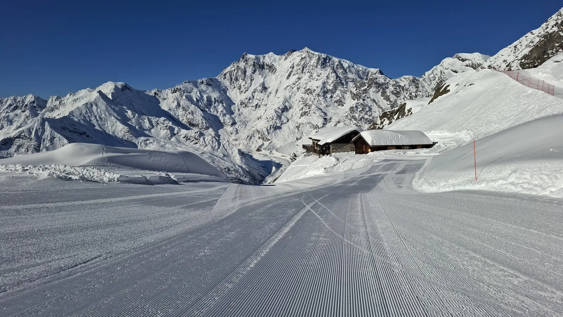 a snowy mountain with a cabin